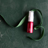 Jane Iredale Pommist Hydration Spray Mini on green background