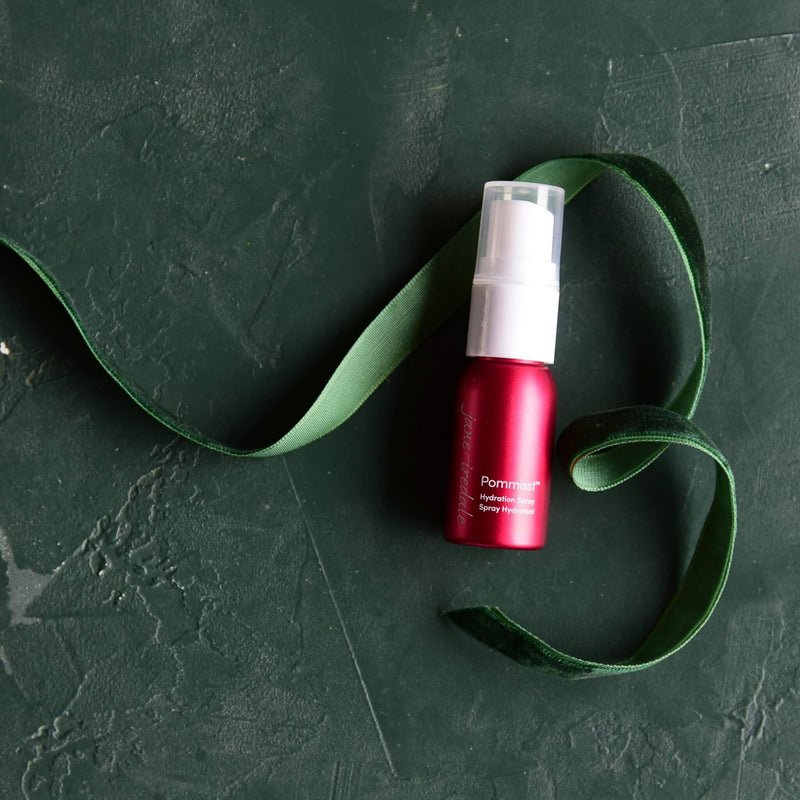 Jane Iredale Pommist Hydration Spray Mini on green background